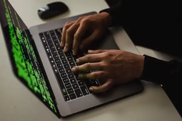 Image of a man programming at a laptop